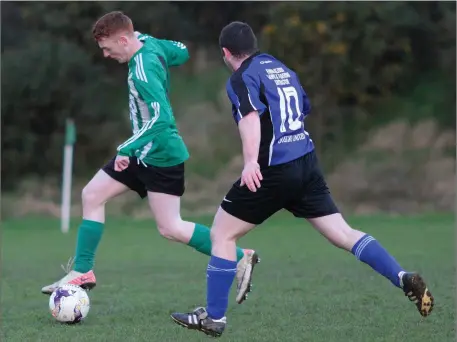  ??  ?? Eddie Power of Caim United in chased by Eoin O’Mahoney of Oylegate United during their Billy Browne Cup match.