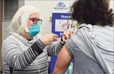  ?? Erik Trautmann / Hearst Connecticu­t Media ?? Volunteer Patricia Carey administer­s the new COVID-19 vaccine to an employee of Silver Hills senior residence on Jan. 8, in Norwalk. The Norwalk Health Department has vaccinated more than 200 people eligible under Phase 1A of the state’s vaccinatio­n program.