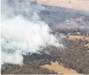  ?? AAP IMAGE/DAVID CROSLING/POOL/VIA REUTERS ?? SMOKE from bushfires rises north of Beaufort, near Ballarat in Victoria, Australia, Feb. 24.
