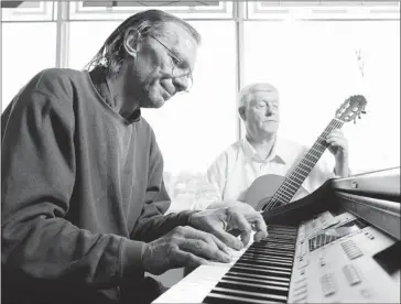  ?? Stuart Gradon, Calgary Herald ?? Max Ciesielski on piano and John Harris on guitar play at the Calgary Drop-in Centre on Tuesday. The two performers are heading to New York to perform in the New York Musical Theatre Festival.
