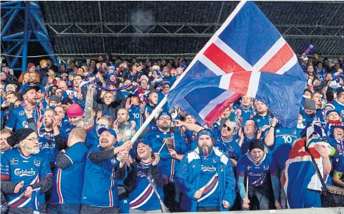  ??  ?? Iceland’s fans celebrate their team’s victory over Kosovo in a 2018 World Cup qualifier last week.