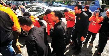  ??  ?? Eight prison officers and an illegal taxi Indonesian woman driver are brought to George Town Sessions/Magistrate’s Court for remand order. — Bernama photo