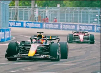  ?? WILFREDO LEE/AP PHOTO ?? Red Bull driver Max Verstappen of the Netherland­s leads Ferrari driver Charles Leclerc of Monaco during the Formula One Miami Grand Prix on Sunday at the Miami Internatio­nal Autodrome.