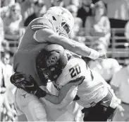  ?? Chuck Burton / Associated Press ?? Texas QB Casey Thompson, left, had a TD pass but was stopped on fourth down late in the game.