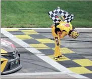  ?? Getty Images - James Gilbert ?? Kyle Busch takes a bow after winning Sunday’s Cup race at Kansas Speedway.