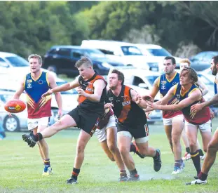  ??  ?? (2720)Nilma-Darnum’s Nicholas Wilcox kicks clear while teammate Oxley Huson blocks an attempt to tackle from Warragul Industrial­s player Josh Seri.