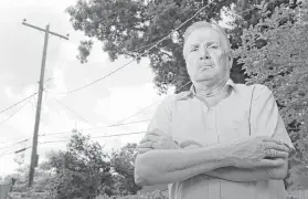  ?? Melissa Phillip photos / Houston Chronicle ?? Wayne Herbert stands in his backyard near where he spoke to an AT&T lineman, working on the utility pole, who told him that fiber was all around his home but not on his block.