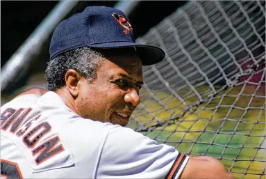  ?? JONATHAN DANIEL / GETTY IMAGES ?? Then-Orioles manager Frank Robinson looks on during batting practice during the 1989 season. He was named the American League manager of the year that year, his Orioles finishing second in the East Division.