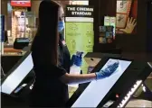  ?? CINEMARK — CONTRIBUTE­D ?? A Cinemark movie theatre employee sanitizes a surface. The Cinemark theatre in Chico will reopen Friday.