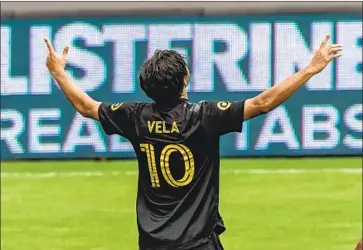  ?? Shaun Clark Getty I mages ?? LAFC’S CARLOS VELA, making just his second appearance since early March because of injury, celebrates his goal against the Galaxy in Sunday’s game. Vela scored in stoppage time against a 10- man Galaxy squad.