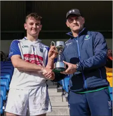 ??  ?? Niall Delahunt receives the ‘B’ cup for St Patrick’s from Hugh Kenny.