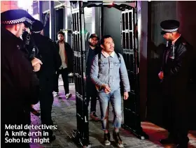  ??  ?? Metal detectives: A knife arch in Soho last night