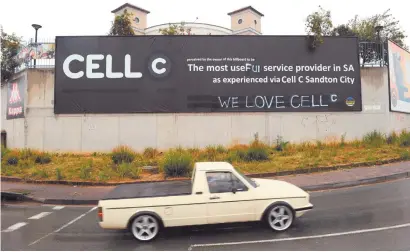  ?? Picture: Michel Bega ?? DOCTORED. A bakkie drives past the banner yesterday in Randburg, which has now been defaced to read ‘ the most useful service provider’. The phrase ‘ We love Cell C’ has also been added.