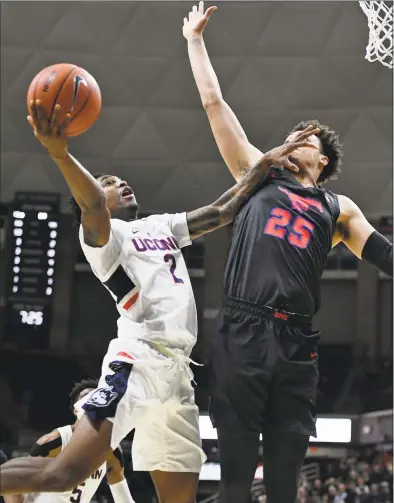  ?? Jessica Hill / Associated Press ?? UConn’s Tarin Smith (2) is fouled by SMU’s Ethan Chargois on Thursday night in Storrs.