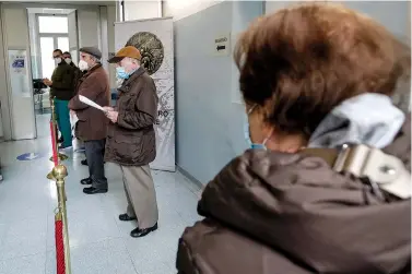  ?? The Associated Press ?? ■ In this Feb. 18 file photo, over eighty-year-old queue as they wait to be administer­ed a dose of the Pfizer/BioNTech vaccine, in a tent set up at the Baggio military hospital in Milan, Italy. In some Italian region lawyers, magistrate­s, professors and other younger profession­als got vaccinated against COVID-19 before octogenari­ans despite government pledges of prioritizi­ng Italy’s oldest citizens.