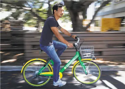  ?? Paul Chinn / The Chronicle ?? Brad Bao, co-founder of Lime Bike, takes a spin on a bike the company hopes will soon be available on S.F. streets.