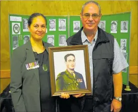  ?? PICTURE / PETER DE GRAAF ?? Melissa Peehikuru with her father Jim Porter and a portrait of her late grandfathe­r Major William Porter, of the 28th Ma¯ ori Battalion, at an Anzac exhibition in Kaeo.