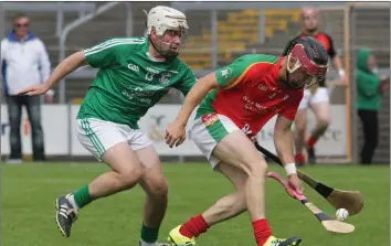  ??  ?? Dillon Redmond (Rapparees) stoops to gather possession as David O’Brien (Naomh Eanna) challenges.