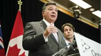  ?? CHRISTOPHE­R KATSAROV/THE CANADIAN PRESS FILE PHOTO ?? Finance Minister Charles Sousa, shown here with Health Minister Eric Hoskins, hopes to tap into the “skills and experience­s of Ontario’s best and brightest,” by setting aside money for ideas from the public.