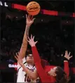  ?? TIM PHILLIS — FOR THE NEWS-HERALD ?? South Carolina’s Kamilla Cardoso shoots over NC State’s River Baldwin on April 5 during the Women’s Final Four at Rocket Mortgage FieldHouse.