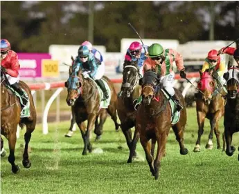  ?? Photo: Nev Madsen ?? STRONG FINISH: Abb Roy finishes strongly out wide for jockey Nori Nishio (green cap) to win Saturday’s Ratings Band 0-55 Handicap at Clifford Park.