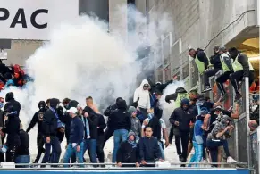  ?? — Reuters ?? Chaos: Anti-riot police firing tear gas to disperse Marseille fans after the Ligue 1 match against Lyon at the Stade Velodrome on Sunday.