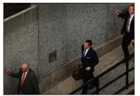  ?? AP/St. Louis Post-Dispatch/DAVID CARSON ?? Flanked by security guards, Missouri Gov. Eric Greitens arrives at court Thursday for jury selection in his felony invasion-of-privacy trial in St. Louis.