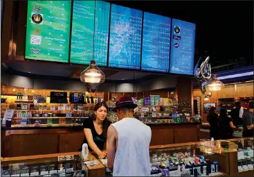  ?? AP/RICHARD VOGEL ?? A patient takes advantage April 20 of special deals celebratin­g the 4/20 holiday at ShowGrow, a medical marijuana dispensary in Los Angeles. Arkansas’ voter-approved constituti­onal amendment allowing medical marijuana use will soon fall into place. The...