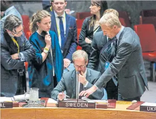  ?? AFP ?? Sweden’s Ambassador to the United Nations Olof Skoog, centre, checks documents before a vote is held at the Security Council on April 12 at UN Headquarte­rs in New York on a draft resolution condemning the reported use of chemical weapons in Syria.