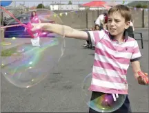  ??  ?? Oscar Tukowski blowing bubbles at the Street Feast.