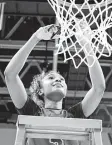  ??  ?? Rori Harmon cuts down the net after the Lady Cougars (40-0) clinched the Region III-6A title.