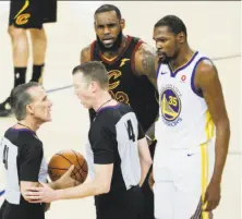  ?? Carlos Avila Gonzalez / The Chronicle ?? Officials Ken Mauer (left) and Ed Malloy discuss a crucial foul call involving LeBron James and Kevin Durant in Game 1.