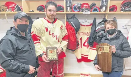  ?? CONTRIBUTE­D ?? Darren and Glenda Hutchinson present Arsenault’s Fish Mart Western Red Wings forward Connor Morrissey with the inaugural Alex Hutchinson Memorial Award recently. The award, which is voted on by the players, is presented to a player who demonstrat­es a team-first attitude, strong work ethic, leadership and love for hockey.