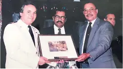  ??  ?? A presentati­on to the captain of a vessel on an inaurgual call to Ocho Rios with Harry Maragh (centre), then managing director, Lannaman &amp; Morris Shipping; Alan Gotting, then director of cruise shipping, and then director, Vance Lannaman, Lannaman &amp; Morris Shipping.