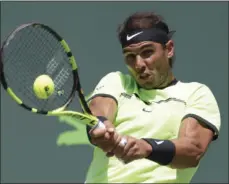  ??  ?? Rafael Nadal, of Spain, hits a return to Fabio Fognini, of Italy, during a men's semifinal match at the Miami Open tennis tournament Friday in Key Biscayne, Fla. AP PHOTO