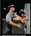  ?? People hug and cry early Monday outside the Thomas & Mack Center. Dozens were killed and more than 500 injured in the massacre. ETHAN MILLER / GETTY IMAGES ??