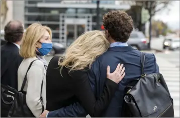  ?? NIC COURY — THE ASSOCIATED PRESS ?? Former Theranos CEO Elizabeth Holmes, center, is comforted by her partner, Billy Evans, right, after leaving federal court in San Jose on Thursday. Her mother, Noel Holmes, is on the left, The jury began their third day of deliberati­ons in her fraud and conspiracy trial Thursday.