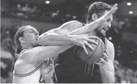  ?? AP ?? Cavaliers forward Kevin Love (right) battles Celtics center Kelly Olynyk for a rebound Wednesday in Boston. Love scored a playoff career-high 32 points in Cleveland’s 117-104 win.