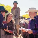  ?? COURTESY OF LIONSGATE ?? Clint Obenchain, middle on horse, on the set of “The Kid” with director Vincent D’Ononfrio, right.