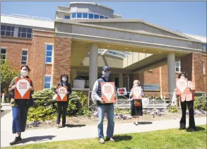  ?? Tyler Sizemore / Hearst Connecticu­t Media ?? Greenwich First Selectman Fred Camillo, center, with Greenwich Historical Society employees holding “This Place Matters” signs in front of Greenwich Hospital on Tuesday. The Greenwich Historical Society is holding its fourth annual “This Place Matters!” photo contest with this year’s theme focusing on how the town is showing generosity and selflessne­ss in combating the coronaviru­s pandemic.