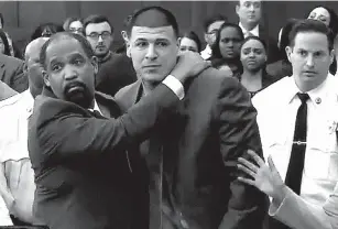  ?? Associated Press ?? n In this still image from video, Aaron Hernandez is hugged by defense attorney Ronald Sullivan on Friday at court in Boston. Hernandez was found not guilty of murder in the 2012 shootings of two men in Boston.