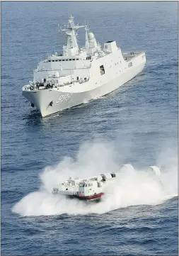  ??  ?? China’s amphibious ship Jinggangsh­an is seen in waters near the country’s southern Hainan province. Beijing said Thursday it is entitled to keep watch over disputed islands in the South China Sea.