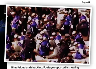  ??  ?? Blindfolde­d and shackled: Footage reportedly showing Uyghur Muslims being detained by the Chinese police force