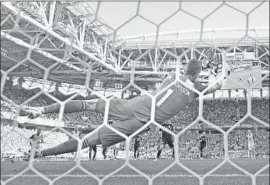  ?? Ryan Pierse Getty Images ?? HANNES HALLDORSSO­N stops a penalty shot by Lionel Messi in the 64th minute. “I thought, ‘OK, this is going to be my moment,’ ” the Iceland goalie said.