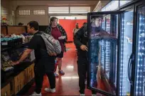  ?? LARRY VALENZUELA — CALMATTERS VIA CATCHLIGHT LOCAL ?? Students look for groceries inside the Ram Pantry at Fresno City College on May 5.