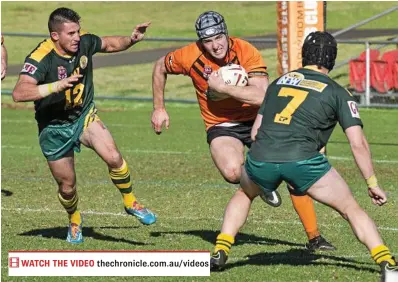  ?? PHOTO: NEV MADSEN ?? RUNNING HARD: Souths’ Matthew Holmes tries to run through the Wattles defence of Ryan Duggan (left) and Joseph Morris.