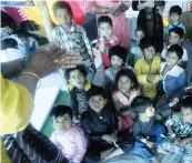  ??  ?? A volunteer demonstrat­es use of hand sanitiser to riothit children at Mustafabad Eidgah relief camp in New delhi on Friday. — PRITAM BANDYOPADH­YAY