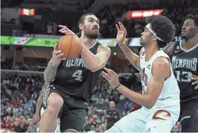  ?? KAREN PULFER FOCHT/AP ?? Grizzlies center Steven Adams drives to the basket while defended by the Cavaliers’ Jarrett Allen on Jan. 18 in Memphis. Adams has been sidelined by a PCL sprain in his right knee.