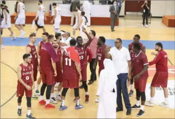  ??  ?? The Qatar team celebrates their win with officials after the match at the Al Gharafa Sports Club on Saturday.