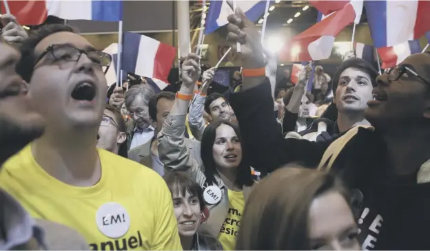  ?? PICTURE: THIBAULT CAMUS /AP ?? 0 Supporters of the French centrist candidate Emmanuel Macron cheering outside his election day headquarte­rs in Paris yesterday